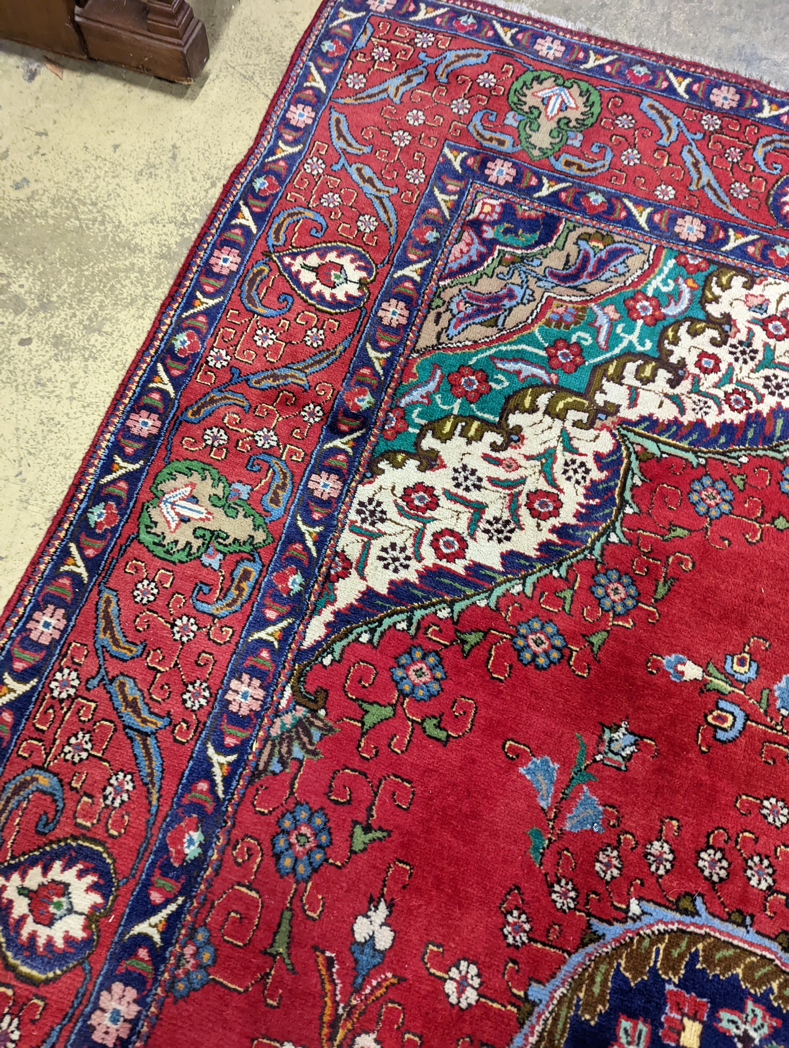 A Tabriz red ground carpet, 380 x 300cm